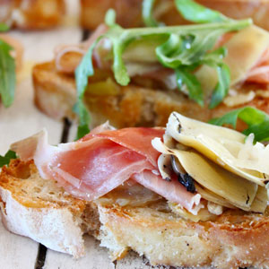 bruschetta with squashed garlic artichokes and parma ham