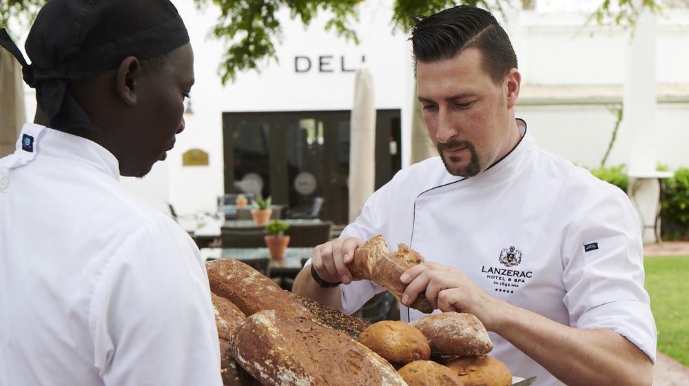 executive chef, Stephen Fraser at Lanzerac, checking quality of bakery's bread